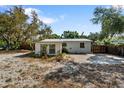 Rear exterior view of the home with a concrete parking space and fenced perimeter at 4112 Alafia Blvd, Brandon, FL 33511