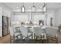 Well-lit eat-in kitchen features a center island, stainless steel appliances and white cabinets for storage at 4517 Foley Grove Dr, Valrico, FL 33596