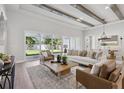 Bright living room features contemporary furniture, a tray ceiling, and a seamless transition to the outdoors at 4517 Foley Grove Dr, Valrico, FL 33596