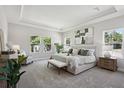 Spacious main bedroom with a tray ceiling, ample natural light, and neutral decor at 4517 Foley Grove Dr, Valrico, FL 33596