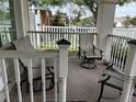 Cozy front porch with tile flooring and comfortable seating, perfect for relaxing outdoors at 5207 S 86Th St, Tampa, FL 33619