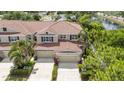 Beautiful aerial view of a townhome, highlighting the roof, lush landscaping, and spacious driveway at 5312 6Th N Way, St Petersburg, FL 33703