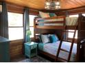 Charming bedroom featuring a wooden bunk bed and stylish turquoise accents at 5341 Circle Dr, Weeki Wachee, FL 34607