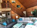 Vaulted wood ceiling living room with stone accents, two sofas, and decor at 5341 Circle Dr, Weeki Wachee, FL 34607