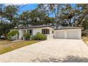Exterior of this home showing a large driveway with an attached two-car garage at 5415 Park Pl, Tampa, FL 33603