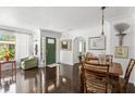 Warm and inviting foyer with original hardwood flooring, classic decor and green front door at 5415 Park Pl, Tampa, FL 33603