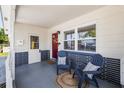 Inviting covered front porch with seating and a stylish red front door at 5642 19Th N Ave, St Petersburg, FL 33710