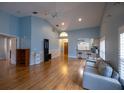 Bright, open living room with high ceilings, hardwood floors, and a cozy seating area at 6438 Brentwood Dr, Zephyrhills, FL 33542