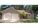 Charming single-story home featuring a two-car garage, landscaped yard, and a classic front entrance at 6994 Fort King Rd, Zephyrhills, FL 33541