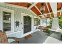 Inviting front porch with a wooden swing and a stylish pineapple pendant light at 1001 S Oregon Ave, Tampa, FL 33606