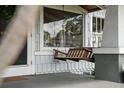 Close-up of front porch with a wooden swing and stylish exterior at 1001 S Oregon Ave, Tampa, FL 33606