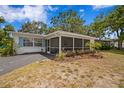 Charming home with a screened lanai and well-maintained landscaping at 10442 Cirimoya Ln, Seminole, FL 33772