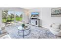 Inviting living room featuring a glass-top coffee table and sliding doors to a cozy balcony at 1120 N Shore Ne Dr # 201, St Petersburg, FL 33701