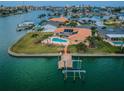 Beautiful waterfront home with a private dock, pool, and tropical landscaping at 11625 5Th E St, Treasure Island, FL 33706