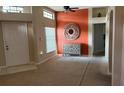 Bright living room features neutral colors, plush carpeting, and large windows providing ample natural light at 1510 Sakonnet Ct, Brandon, FL 33511