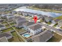 Aerial view of the home showcasing a private backyard pool in a lakeside community at 15959 Tuscany Hillside Rd, Odessa, FL 33556