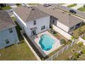 Aerial view of a private backyard with a kidney-shaped pool and patio seating at 15959 Tuscany Hillside Rd, Odessa, FL 33556