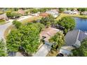 Overhead view of a private residence backing onto a pond with mature trees and landscaping at 19227 Garden Quilt Cir, Lutz, FL 33558