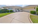 Close up of the home's driveway and manicured front lawn and landscaping at 2003 Wedge Ct, Sun City Center, FL 33573