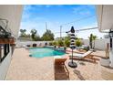 Relaxing backyard oasis with a sparkling pool, brick patio, and ample space for outdoor entertaining at 2250 64Th N St, St Petersburg, FL 33710