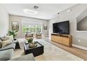 Open-concept living room showcasing contemporary furniture, a flat-screen TV, and large windows at 2547 Lexington Oak Dr, Brandon, FL 33511