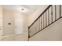 Welcoming entryway with stairs, showcasing modern railing and tile flooring at 2882 Autumn Rock Dr, Zephyrhills, FL 33540