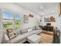 Comfortable living area with a gray sectional, shutters, and a dedicated workspace at 3008 S Church Ave, Tampa, FL 33629