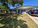 Charming single Gathering home with a well-maintained front yard and car port at 315 Shore E Dr, Oldsmar, FL 34677