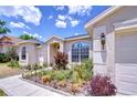 Beautiful landscaping and vibrant plants adorn the front of this well-maintained single story home at 316 Crystal Goblet Ct, Valrico, FL 33594