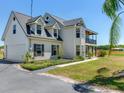 This lovely two-story home features a balcony, dormer windows, and a manicured front lawn at 3434 E Keysville Rd, Lithia, FL 33547