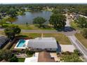 Aerial view of a home with a private pool and nearby lake in a desirable residential neighborhood at 4421 28Th N Ave, St Petersburg, FL 33713