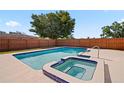 Backyard pool with a spa and tiled trim, surrounded by a well-maintained patio and a wooden fence at 4421 28Th N Ave, St Petersburg, FL 33713