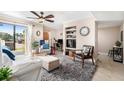 Bright living room featuring a comfortable sofa, stylish rug, and a sliding door to the outside at 455 Alt 19 S # 65, Palm Harbor, FL 34683