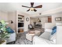 Comfortable living room open to dining area, features a ceiling fan and built in shelving at 455 Alt 19 S # 65, Palm Harbor, FL 34683