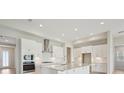 Bright and airy kitchen featuring stainless steel appliances, subway tile backsplash, and a spacious island at 5194 Everlong Dr, Apollo Beach, FL 33572