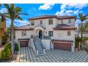 Stunning two-story home featuring a tiled roof, well-maintained landscaping, and a grand staircase leading to the front entrance at 5939 Bayview S Cir, Gulfport, FL 33707