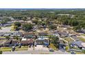 Aerial view of a residential neighborhood with mature trees, single-Gathering homes, and manicured lawns at 6428 Moss Way, Tampa, FL 33625