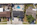 Overhead view of backyard with a kidney-shaped pool, lush landscaping, and lounge chairs at 6428 Moss Way, Tampa, FL 33625