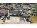 Aerial view of a well-maintained home with a large yard, landscaped with a mature palm in the front yard at 6428 Moss Way, Tampa, FL 33625