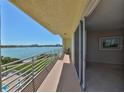 Enjoy water views from this condo balcony with white railings and sliding glass door access to the interior at 7882 Sailboat Key S Blvd # 401, South Pasadena, FL 33707