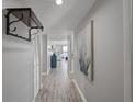 Long hallway features wood floors and neutral paint leading to a naturally lit living space with water views at 7912 Sailboat Key S Blvd # 508, South Pasadena, FL 33707