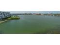 Expansive waterfront view showcasing tranquil waters, verdant landscaping, and buildings in the distance at 7912 Sailboat Key S Blvd # 508, South Pasadena, FL 33707