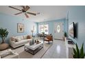 Bright living room showcasing modern decor, white tile flooring, and ample natural light at 9118 108Th Ave, Seminole, FL 33777