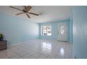 Neutral living room featuring tile flooring and a large window providing natural light at 9118 108Th Ave, Seminole, FL 33777