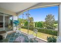 Relax on this screened patio with golf course views, tile flooring, and comfortable seating in an inviting outdoor space at 919 Osceola Rd # 202, Belleair, FL 33756