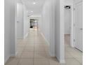 Long hallway with light tile, leading to other rooms in the house at 13227 Waterleaf Garden Cir, Riverview, FL 33579