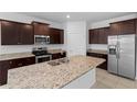 Spacious kitchen features granite countertops, stainless steel appliances, and ample cabinet space at 13227 Waterleaf Garden Cir, Riverview, FL 33579