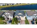 A picturesque aerial view of a home by the lake with mature landscaping and backyard privacy at 13651 Ashlar Slate Pl, Riverview, FL 33579
