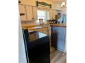 Cozy kitchen featuring white cabinetry, wood countertops and modern appliances at 1379 Pine St, Clearwater, FL 33756