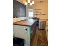 Rustic kitchen with a butcher block island, ample storage, and stainless steel appliances at 1379 Pine St, Clearwater, FL 33756